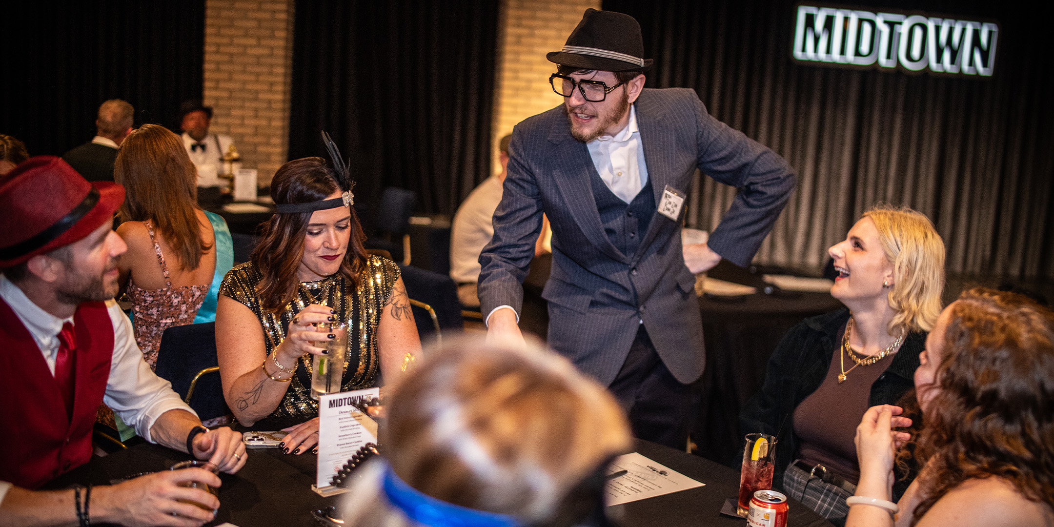 Guests at a Murder Mystery Company public dinner show in Newark